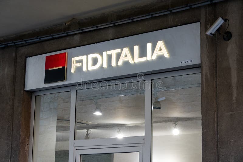 ENNA, SICILY - FEBRUARY 11, 2020: The storefront of the Fiditalia Bank which belongs to Societe Generale financial group at night with illuminated logo. ENNA, SICILY - FEBRUARY 11, 2020: The storefront of the Fiditalia Bank which belongs to Societe Generale financial group at night with illuminated logo