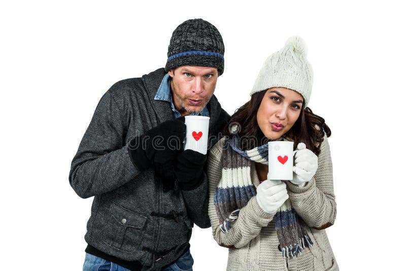 Winter couple enjoying hot drinks on white background. Winter couple enjoying hot drinks on white background