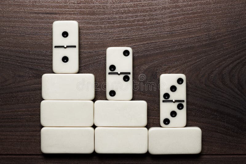 White domino pieces forming podium win concept background. White domino pieces forming podium win concept background