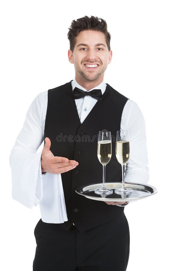 Portrait of confident waiter carrying champagne flutes on tray over white background. Portrait of confident waiter carrying champagne flutes on tray over white background