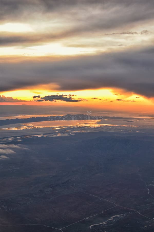 De Zonsondergangsatellietbeeld van Great Salt Lake van vliegtuig die in Wasatch Rocky Mountain Range, cloudscape en landschap Uta stock foto De Zonsondergangsatellietbeeld van Great Salt Lake van vliegtuig die in Wasatch Rocky Mountain Range, cloudscape en landschap Uta stock foto
