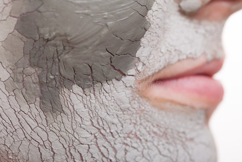 Skin care. Closeup of female face. Young woman applying clay mask. Girl taking care of her dry compexion. Isolated. Spa and beauty treatment. Skin care. Closeup of female face. Young woman applying clay mask. Girl taking care of her dry compexion. Isolated. Spa and beauty treatment.