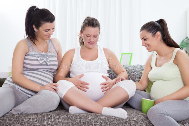 Smiling pregnant women communicates – indoors. Smiling pregnant women communicates – indoors