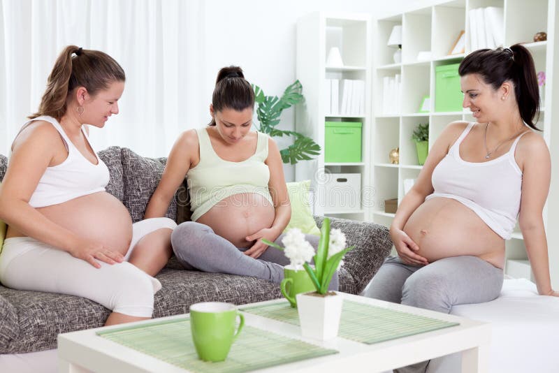 Smiling pregnant women communicates – indoors. Smiling pregnant women communicates – indoors