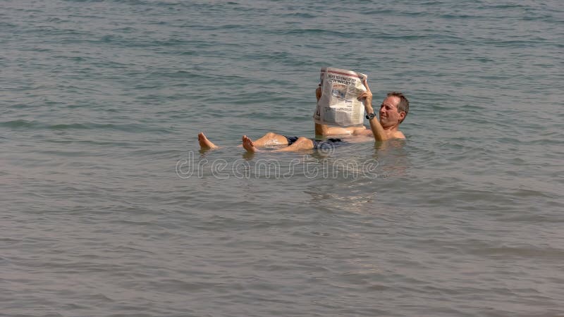 picture Person Floating In Water Side View man floating dead sea jordan photos