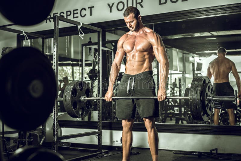 Deadlifts en gimnasio moderno imagen de archivo Deadlifts en gimnasio moderno imagen de archivo