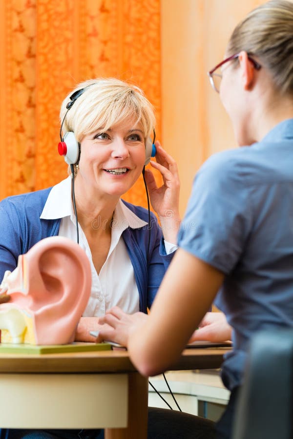 Deaf woman takes a hearing test royalty free stock photo Deaf woman takes a hearing test royalty free stock photo