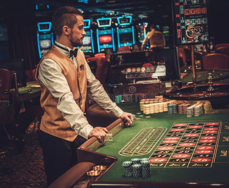 Dealer Behind Table in a Casino Stock Photo Image of poker, people