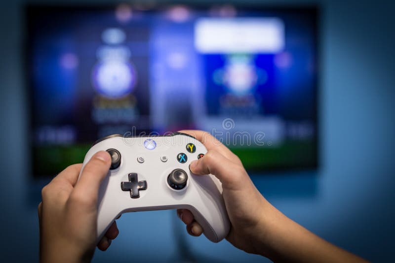 man with a controller standing in front of a PC console TV screen with a  steam controller playing popular free to play game Roblox Stock Photo -  Alamy