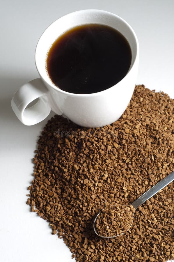 Pile of Decaffeinated coffee granules with spoon and cup