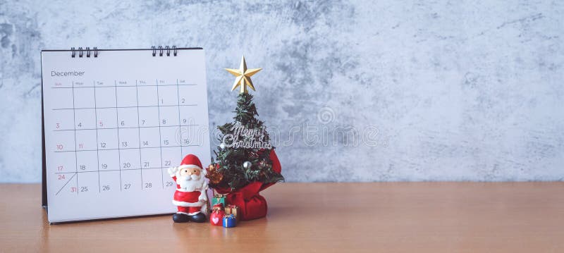 December calendar and Christmas decoration - Santa Clause, tree and gift on wooden table. Christmas and Happy new year concept