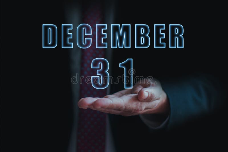 December 31st. Day 31of month, announcement of date of business meeting or event. businessman holds the name of the month and day royalty free stock image December 31st. Day 31of month, announcement of date of business meeting or event. businessman holds the name of the month and day royalty free stock image