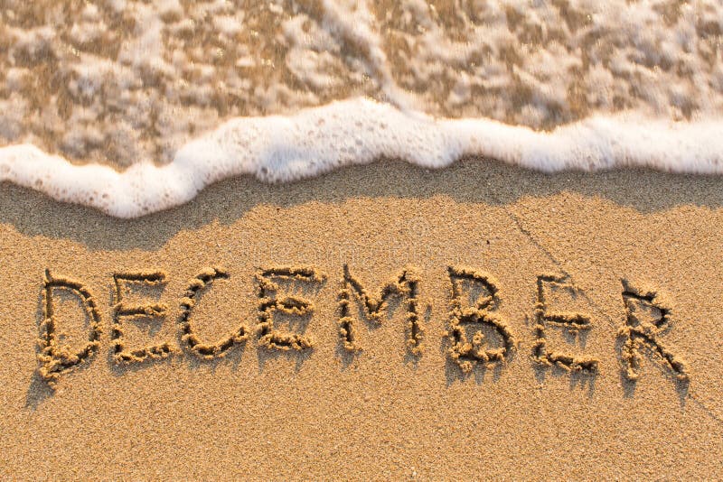 December Word Drawn on the Sand Beach with the Soft Wave. Stock Image