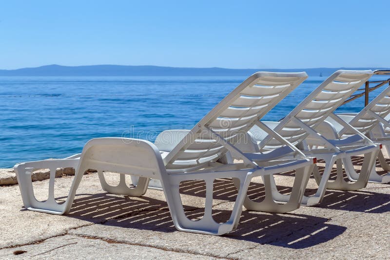Deck chair on the beach stock photo. Image of travel - 113583642