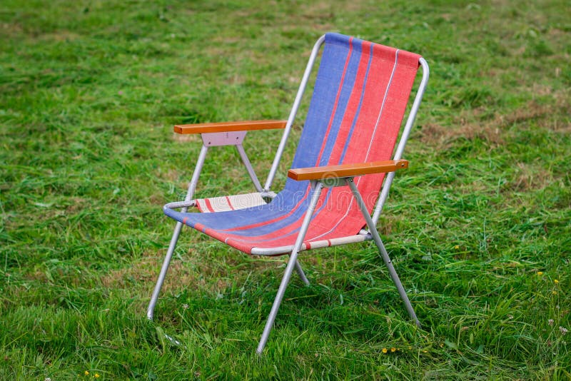Deckchair on Grass. Lawn Chairs in the Park Empty Park Stock Photo