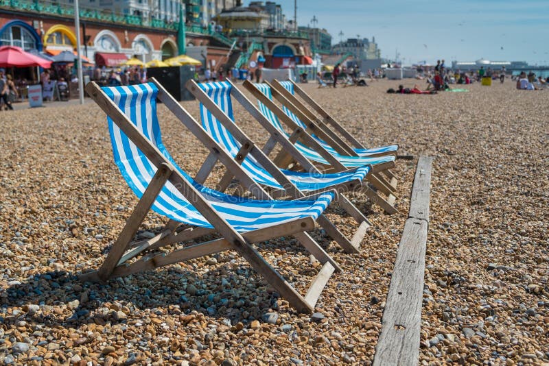 4 deck chairs on Brighton beach