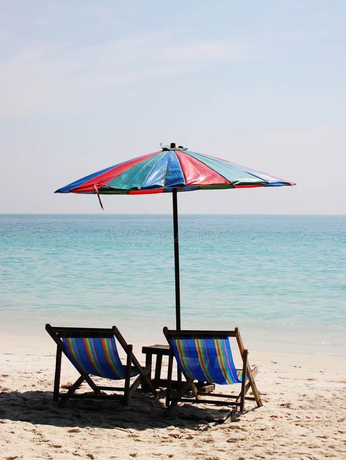 Deck chairs on a white sandy beach