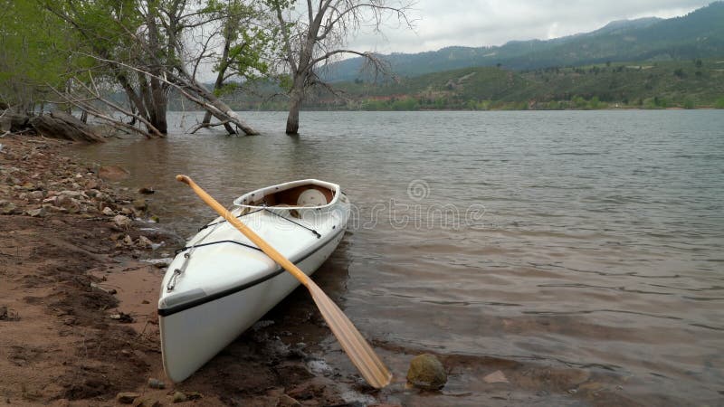 Decked Expedition Canoe with a Wooden Paddle Stock Footage - Video