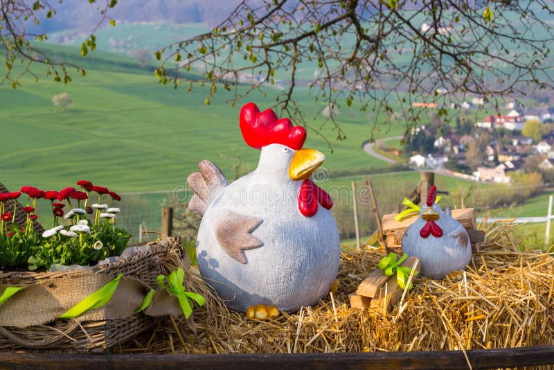 Decoración de aldeas con gallinas de arcilla sobre paja y flores imagen de archivo libre de regalías Decoración de aldeas con gallinas de arcilla sobre paja y flores imagen de archivo libre de regalías