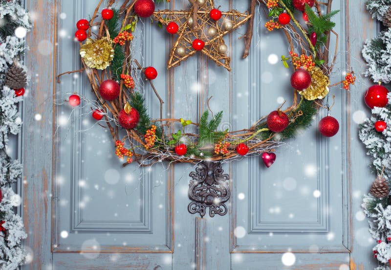 Christmas Wreath decoration at door for holiday. Winter Time, close up. Christmas Wreath decoration at door for holiday. Winter Time, close up