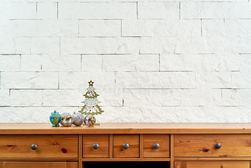 Christmas decoration with beautiful colorful baubles on the old shelf on the background of a white brick wall. Christmas decoration with beautiful colorful baubles on the old shelf on the background of a white brick wall