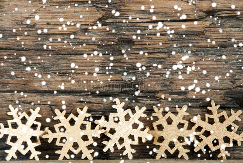 Golden Christmas Snowflakes on Wood with Snow. Golden Christmas Snowflakes on Wood with Snow