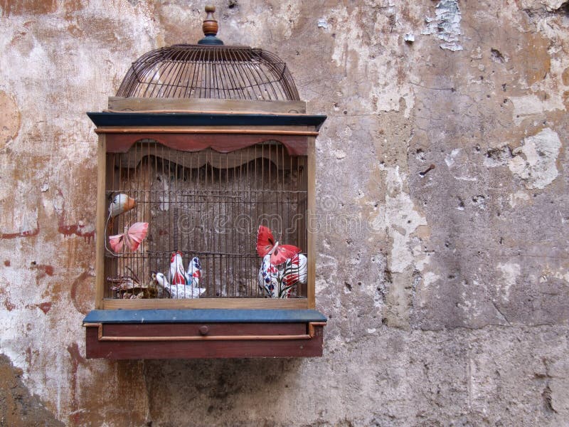 Vintage bird cage as a decoration outside old bookshop in Rome (Italy). Vintage bird cage as a decoration outside old bookshop in Rome (Italy).