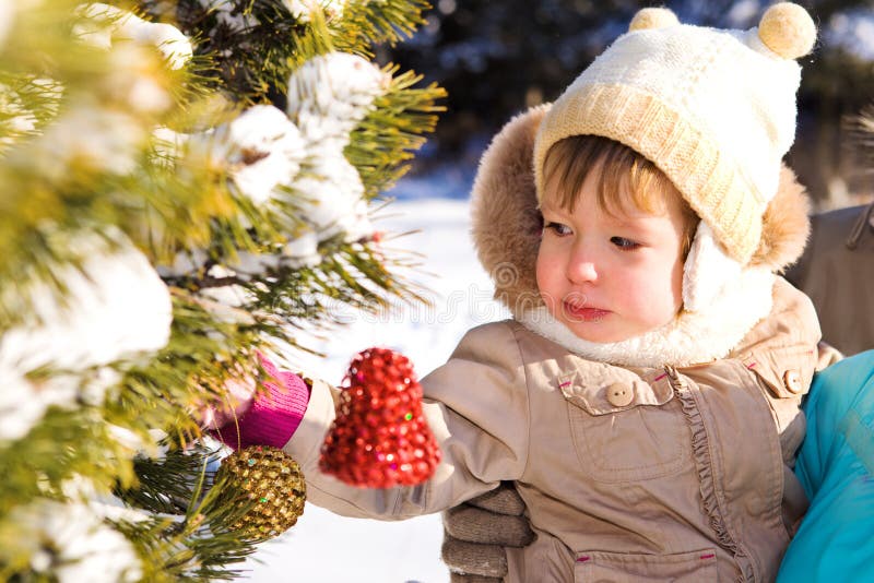 A kid decorating Christmas tree. A kid decorating Christmas tree