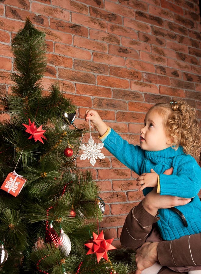 Father and his little daughter decorating Christmas tree. Father and his little daughter decorating Christmas tree