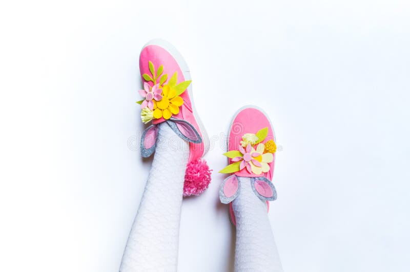 Decorate pink sneakers diy. Baby feet up. Easter holiday rabbit