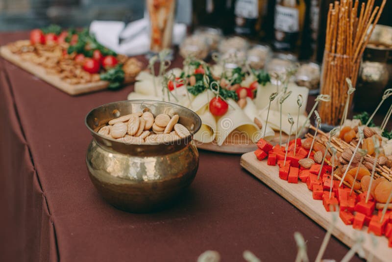 Decorated catering banquet table with different food snacks, sausage,salami,pepperoni sliced royalty free stock images Decorated catering banquet table with different food snacks, sausage,salami,pepperoni sliced royalty free stock images