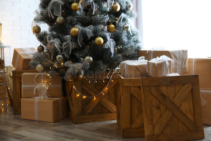 Decorated Christmas Tree and Gift Boxes in Room Interior Stock Image