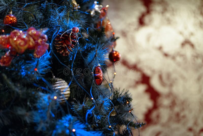 Decorated christmas tree with red toys. Gold background royalty free stock photos