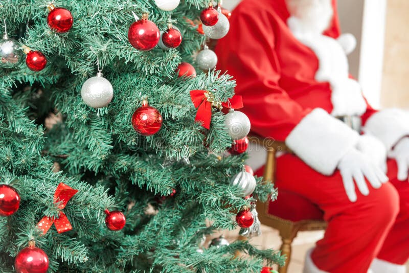 Decorated Christmas Tree With Santa Claus Sitting royalty free stock photography