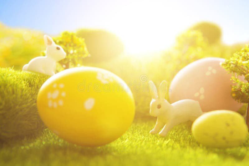 Decorated easter eggs with easter rabbit on grass over sky background. Happy Easter royalty free stock photography