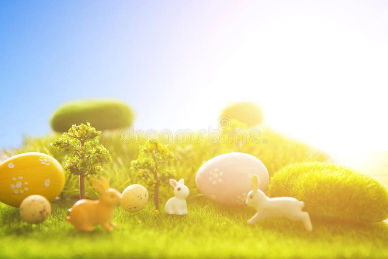 Decorated easter eggs with easter rabbit on grass over sky background. Happy Easter stock image