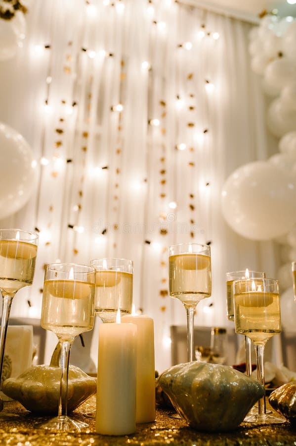 Decorated table for wedding. White balloons, candles, autumn leaves and small pumpkins. Autumn location and Halloween decor. Setting.