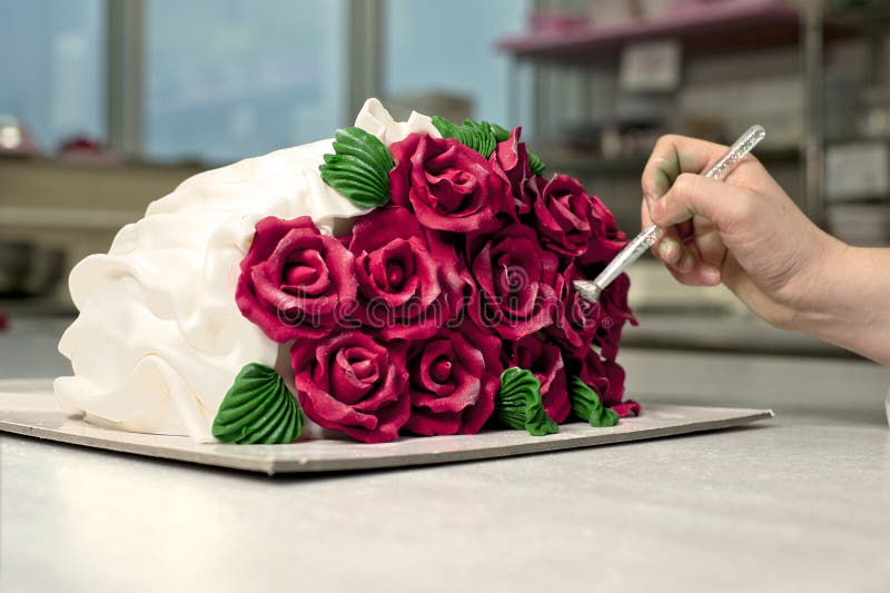 A female chef decorate roses cake. A female chef decorate roses cake