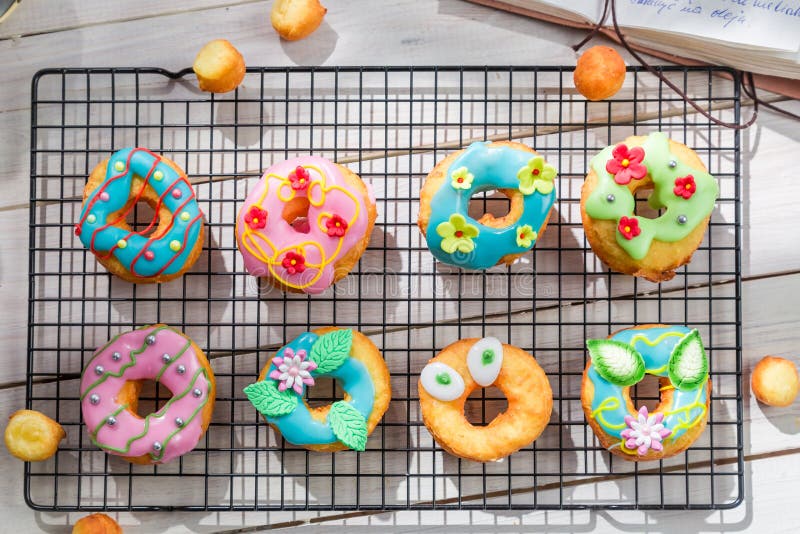 Decorating homemade donuts in the sunny kitchen