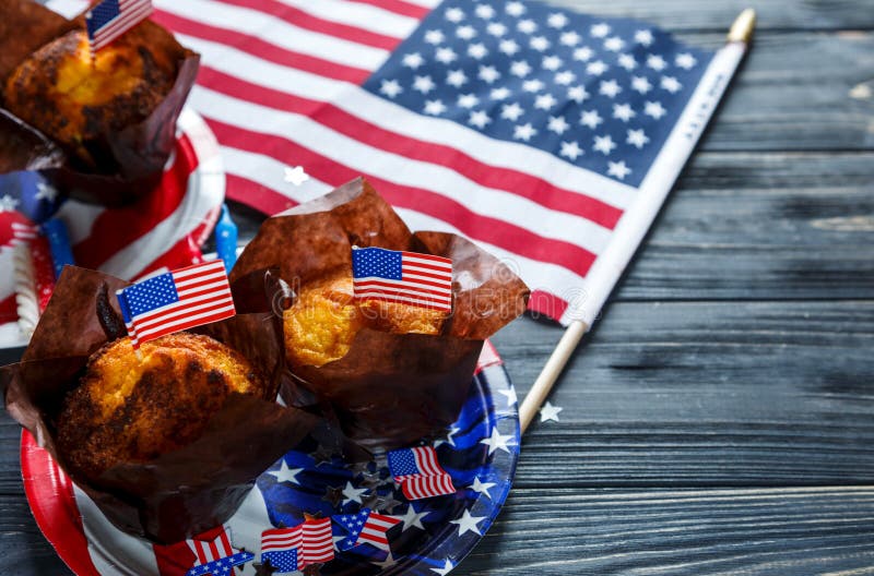 Decorations for 4th of July day of American independence, flag, plates with muffins. USA holiday decorations stock photo Decorations for 4th of July day of American independence, flag, plates with muffins. USA holiday decorations stock photo