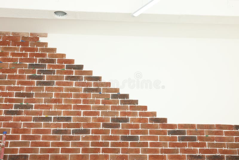 Decorative Bricks with Tile Leveling System on White Wall Stock Photo