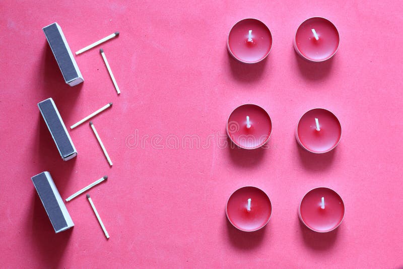 Decorative Candles, Matchboxes and Matches are Arranged in a Row. on a