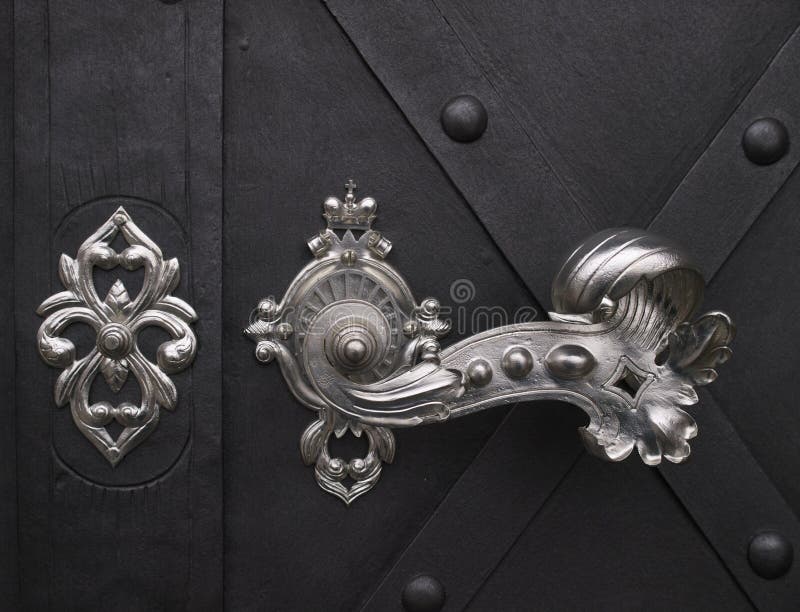 Decorative Handle Of Twisted Metal Wires On A Wooden Door Stock Image