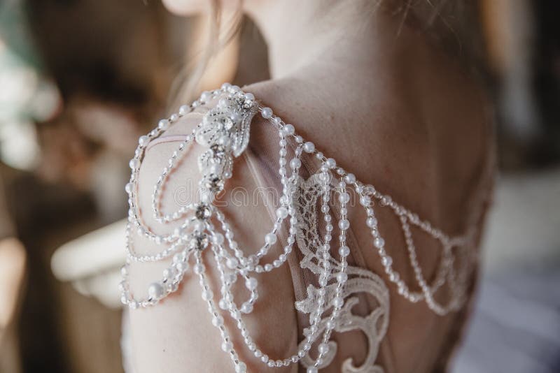 Decorative Elements of the Wedding Dress on the Bride`s Shoulders