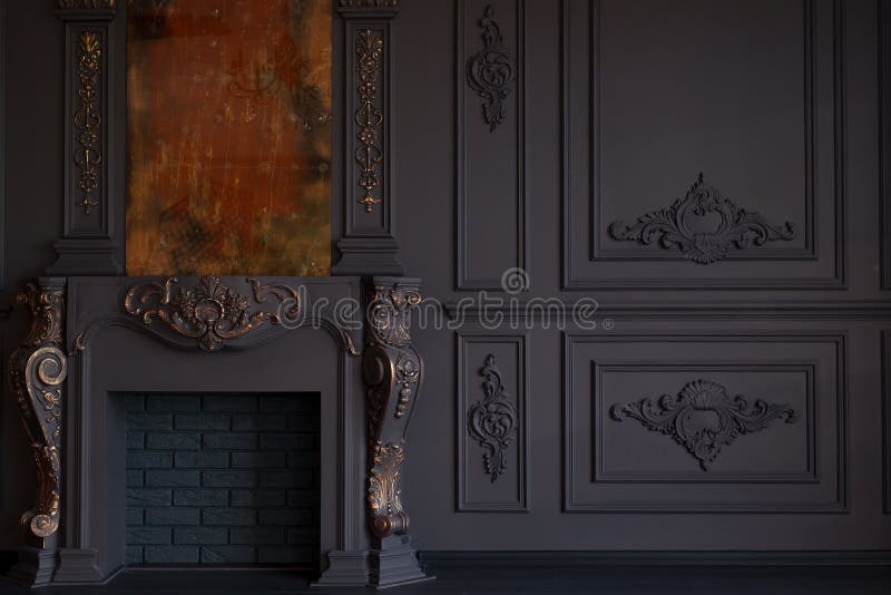 Decorative fireplace, vintage mirror and chandelier in classical black room interior royalty free stock photography