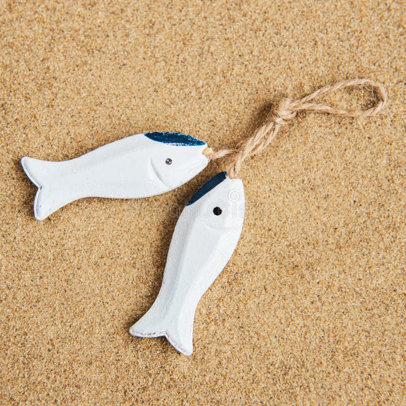 Decorative fish on a sand stock image. Image of coast 114830281