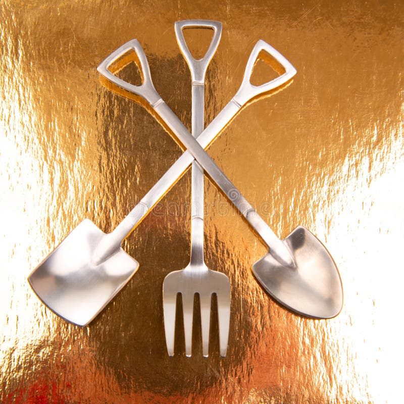 Decorative Fork and Spoons in the Form of Spades on a Golden Background