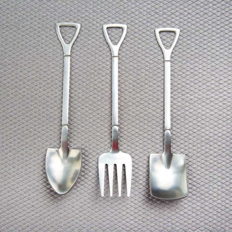 Decorative Fork and Spoons in the Form of Spades on a Gray Background