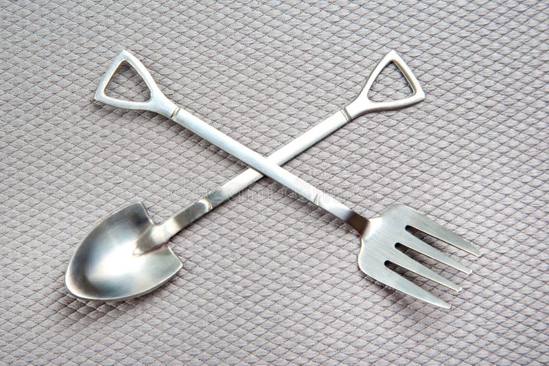 Decorative Fork and Spoons in the Form of Spades on a Gray Background