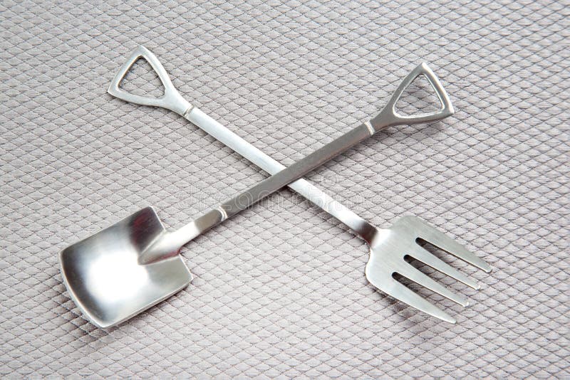 Decorative Fork and Spoons in the Form of Spades on a Gray Background
